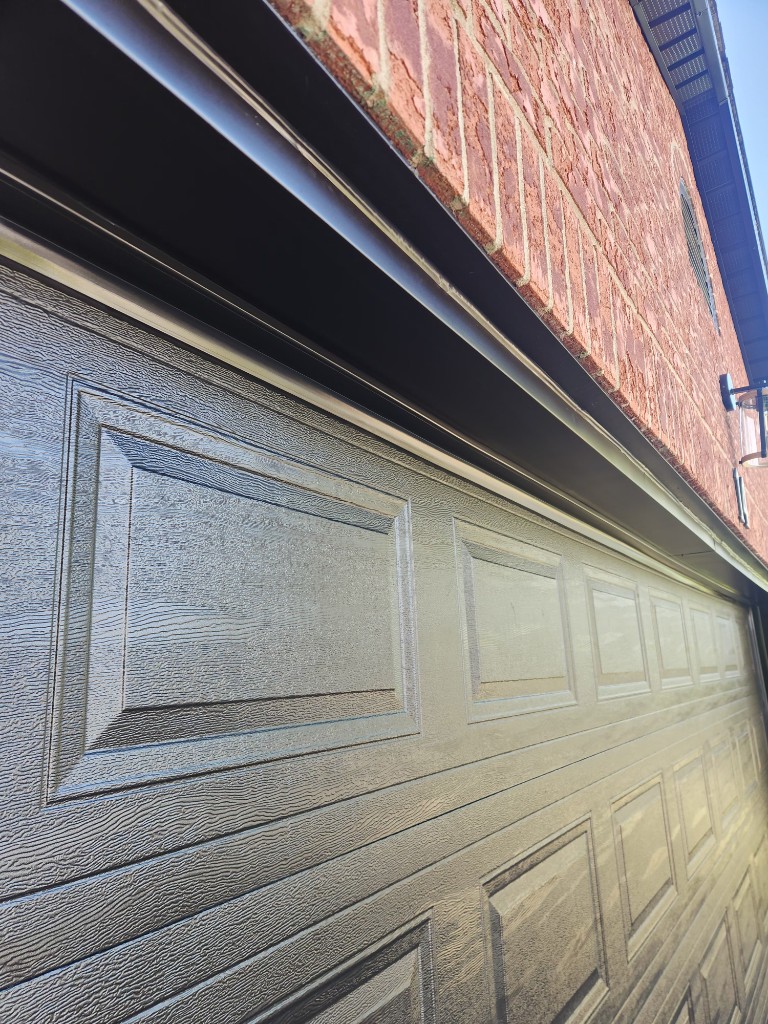 Dark grey garage door with top weatherstripping — winter prep in Ottawa