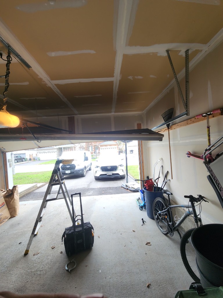Garage door stuck crooked halfway open — emergency repair Ottawa
